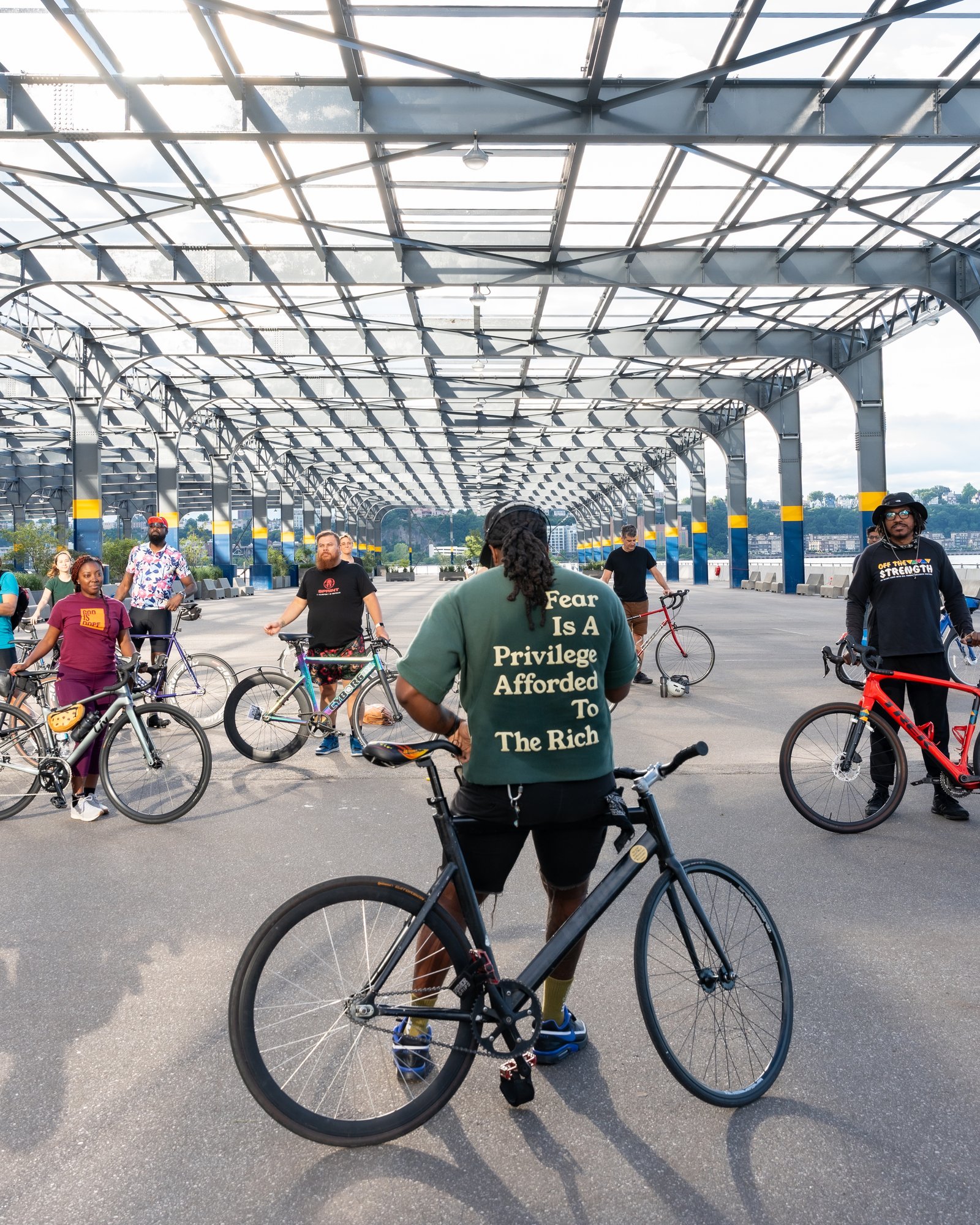 Group of cyclists gathered under the Pier 76 pavilion before a bike yoga session