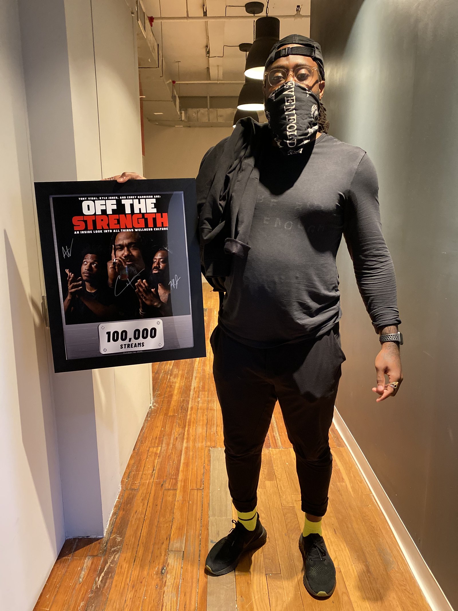 Holding a framed Off The Strength 100,000 streams award plaque