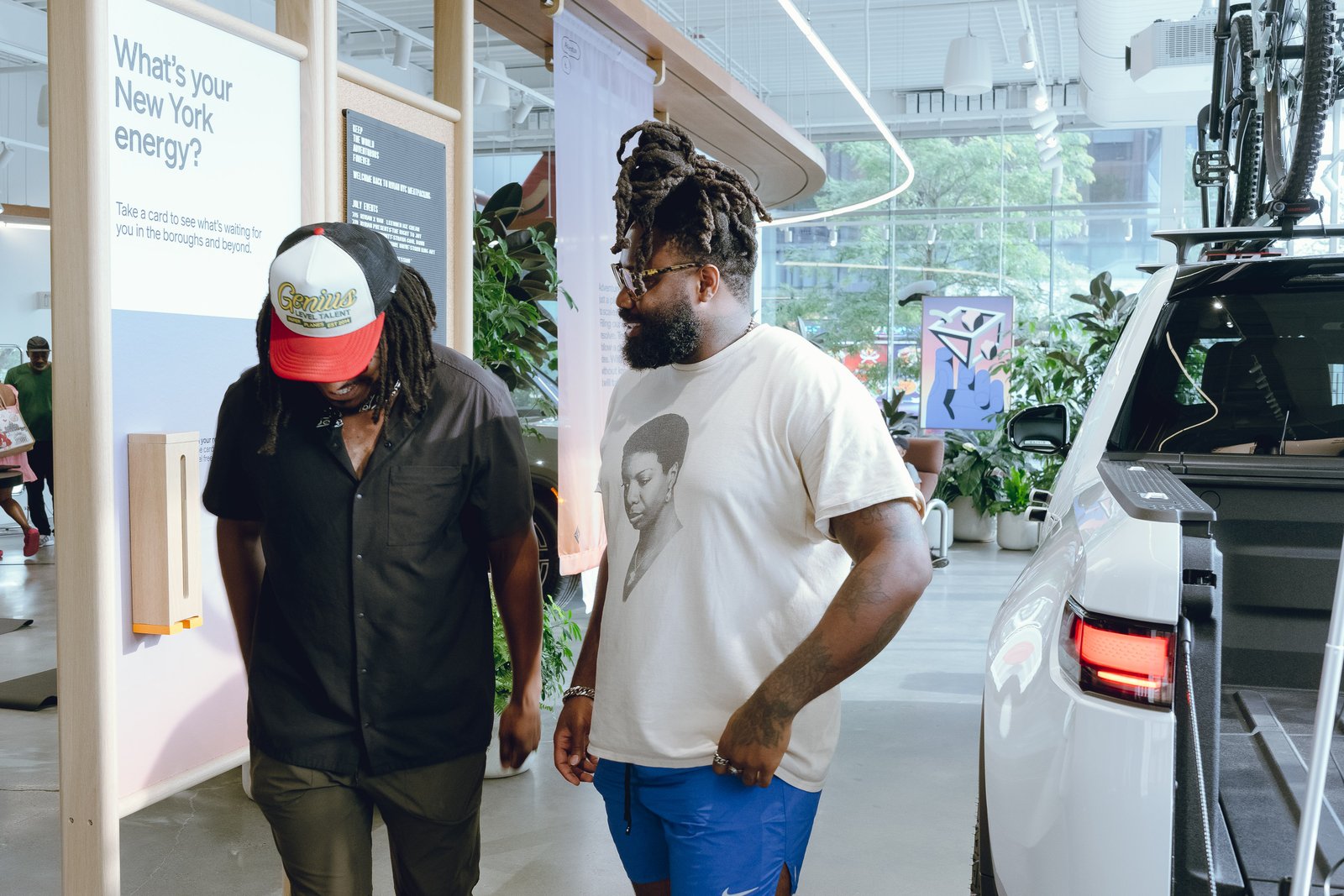 Leading a wellness activation inside a Rivian showroom, walking past the vehicle display