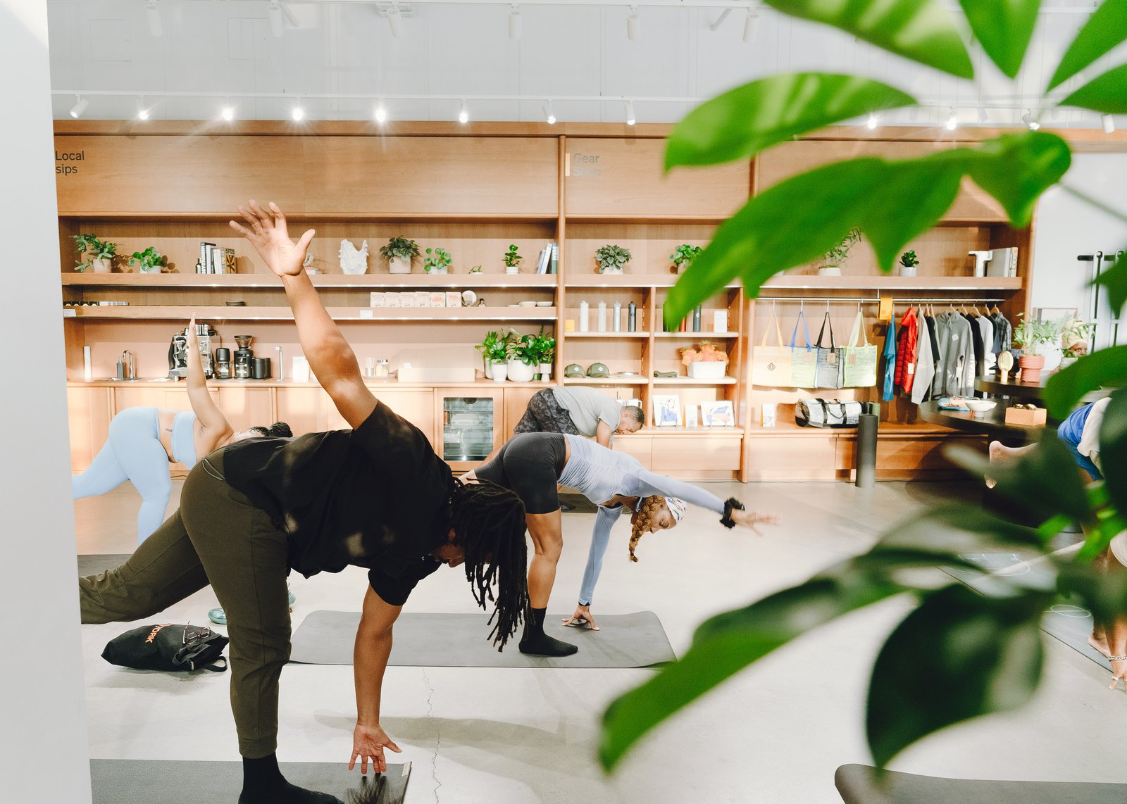 Guiding a lunging stretch pose for attendees near the Rivian gear shop