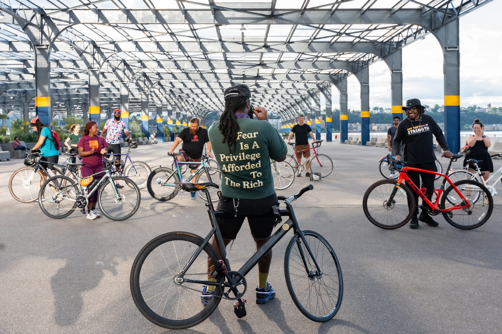 Group bike ride gathered under an outdoor pavilion in NYC
