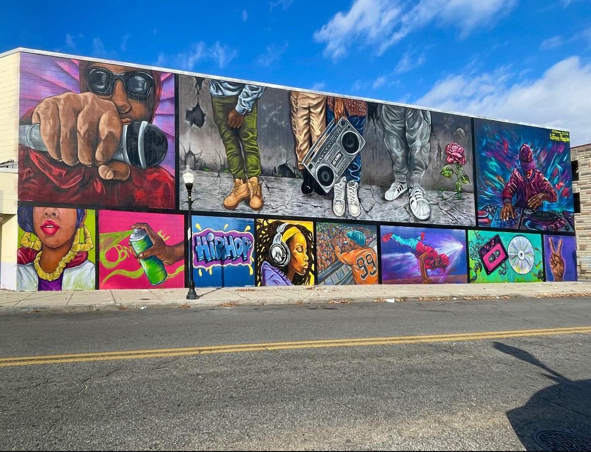 Colorful hip-hop culture mural with panels of a DJ, breakdancer, boombox, and graffiti art